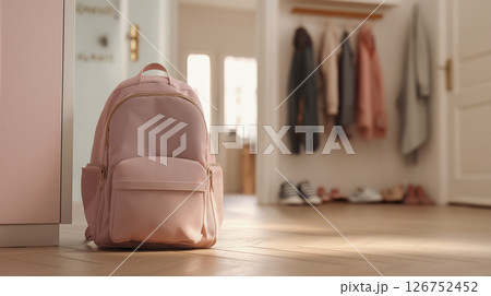 Backpack resting on floor near entrance of home 126752452