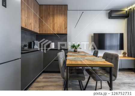Sleek Corner Kitchen with Dining Table 126752731