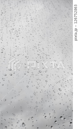 Raindrops sliding on glass during a rainy day in prague copy space 126752863
