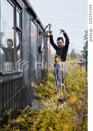 An Eccentric Clown Enjoying Life Amidst Natures Embrace and Vibrant Surroundings An Eccentric Clown Enjoying Life Amidst Natures Embrace and Vibrant Surroundings 126753103
