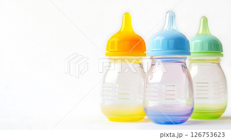 Three baby bottles with different colored lids Three baby bottles with different colored lids 126753623