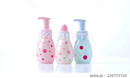 Three bottles of baby lotion with polka dots on them 126753720