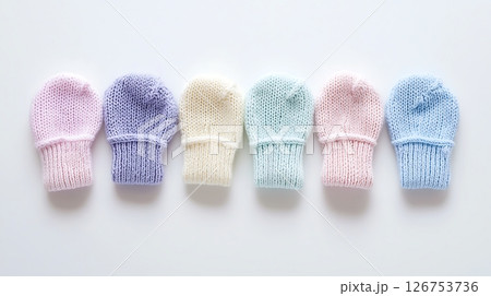 A row of baby mittens in various colors 126753736