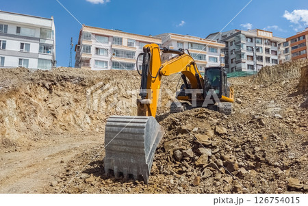 Excavator at urban construction site Excavator at urban construction site 126754015