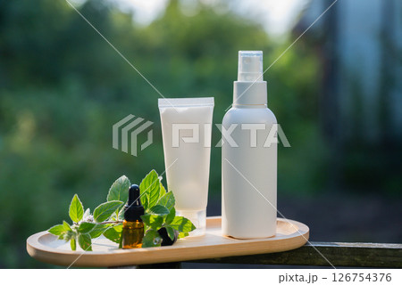 White handmade cosmetic bottles template mockup skin care herbal alternative Insect repellent outdoors during summer. Trying to kill mosquitoes and flies with organic ingredients mint extract oil 126754376