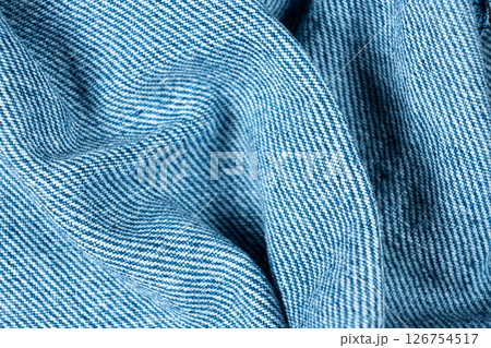 Wavy Pattern of Blue Jean Fabric. Close-Up Textured Wavy Pattern of Blue Jean Fabric. Close-Up Textured 126754517