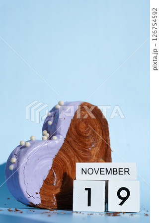 International men's day 19 November wooden calendar cubes wishes greeting holiday card Heartshaped pastry croissant treat topped with colorful frosting galore. Food experimentation viral dessert International men's day 19 November wooden calendar cubes wishes greeting holiday card Heartshaped pastry croissant treat topped with colorful frosting galore. Food experimentation viral dessert 126754592