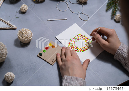 Christmas wreath Storytelling of creating craft Christmas greeting card holiday present. Tactile hand-on activity. Master class progress of creative me-made gifts. Seasonal domestic life micro moment 126754654