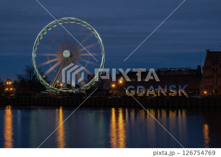 Gdansk Poland Ferris wheel in the old town of Gdansk at night evening dusk Reflection in river water Europe. Long exposure photo. City scenic view Illuminated attraction park and street Gdansk Poland Ferris wheel in the old town of Gdansk at night evening dusk Reflection in river water Europe. Long exposure photo. City scenic view Illuminated attraction park and street 126754769
