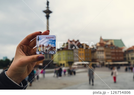 Female woman traveler holding magnet from vacation holiday concept old town main square in Warsaw Poland. City landmarks 126754806