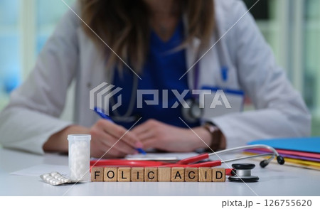 Healthcare Professional Writing on the Importance of Folic Acid for Health and Wellbeing Healthcare Professional Writing on the Importance of Folic Acid for Health and Wellbeing 126755620