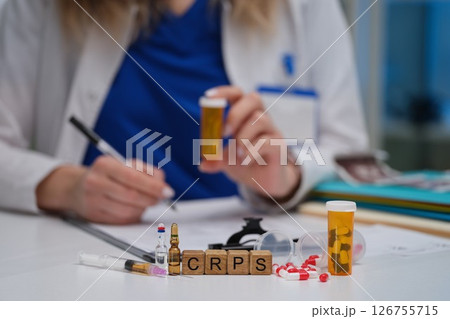 A Healthcare Professional Engaged in Thorough Analysis of CRPS Treatment Options Available A Healthcare Professional Engaged in Thorough Analysis of CRPS Treatment Options Available 126755715