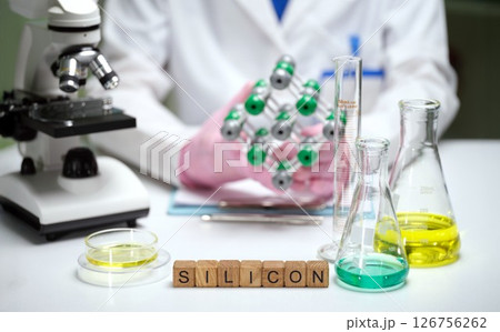 A Silicon Molecule Displayed in a Laboratory Setup with Various Scientific Equipment Present A Silicon Molecule Displayed in a Laboratory Setup with Various Scientific Equipment Present 126756262