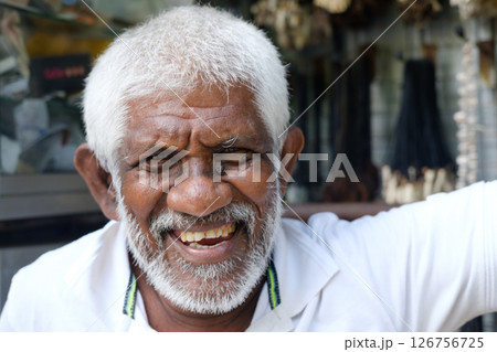 A Joyful Elderly Man Smiling Happily While Enjoying the Outdoors on a Beautiful Day 126756725