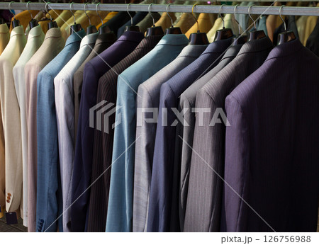 colorful male suits in row in a hanger 126756988