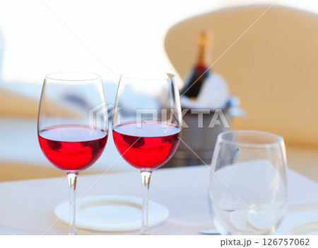 two cups of red wine and bottle in ice bucket 126757062