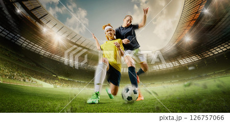 Hand made collage. Two female football players clash mid-action battling for ball, tension rising as bodies lean into power under bright sun. 3D rendering stadium 126757066