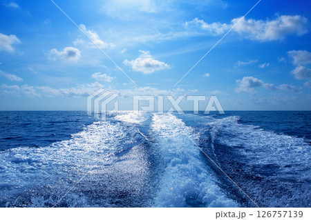 Boat wake prop wash foam in blue sky Boat wake prop wash foam in blue sky 126757139