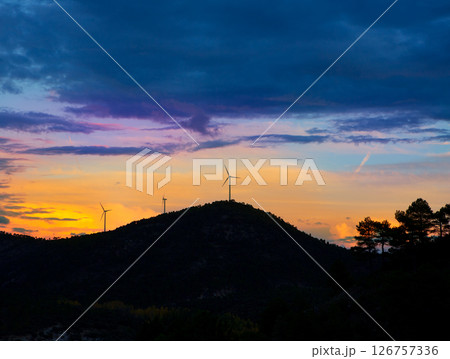 Sunset mountain with electric windmills Sunset mountain with electric windmills 126757336