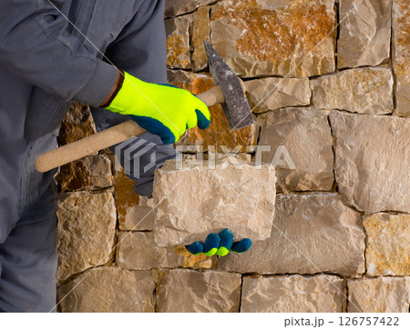 stonecutter mason with hammer and stone working masonry stonecutter mason with hammer and stone working masonry 126757422