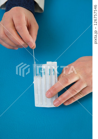 Acupuncture needles in doctor hands holding blister Acupuncture needles in doctor hands holding blister 126757546
