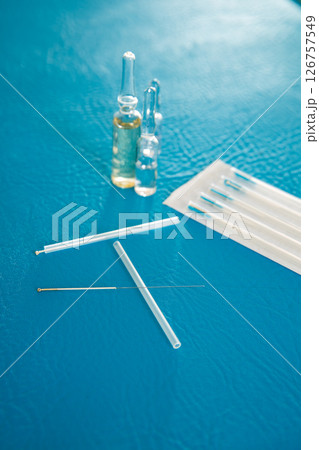 Acupuncture needles set and blister on blue 126757549