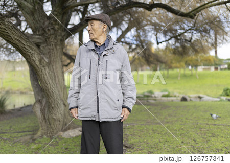 Senior man enjoying music in park, embracing serenity of nature Senior man enjoying music in park, embracing serenity of nature 126757841