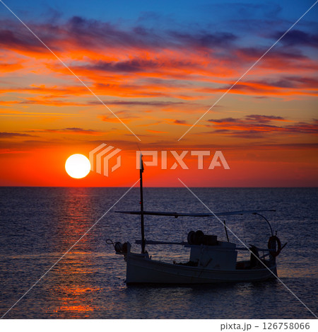 Ibiza sunset view and fisherboat formentera Ibiza sunset view and fisherboat formentera 126758066