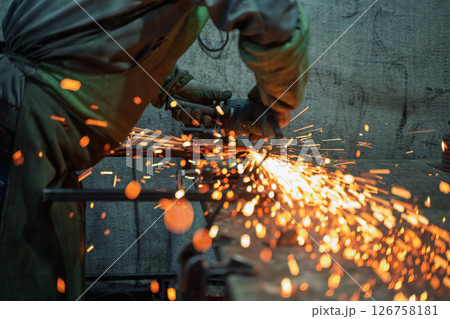 Close-Up of Angle Grinder Creating Sparks in Metal Workshop Close-Up of Angle Grinder Creating Sparks in Metal Workshop 126758181