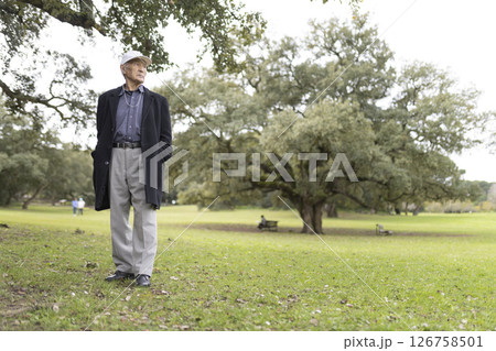 Senior man enjoying nature in green city park 126758501
