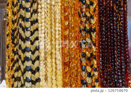Amber Beads in a Street Shop. Orange Baltic Sea Souvenir, Natural Jewelry, Gold Brown Stone Necklace 126758670
