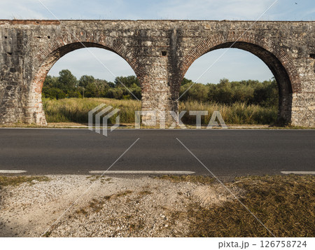ancient roman aqueduct with arched architecture ancient roman aqueduct with arched architecture 126758724