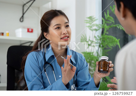 Health and Wellness. Doctor discussing medication with patient in a consultation. Health and Wellness. Doctor discussing medication with patient in a consultation. 126759927