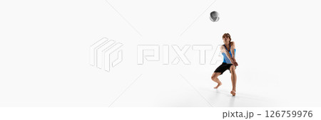Banner. Volleyball player in ready stance with hands joined waits for the ball during match against white studio background with negative space 126759976
