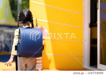 Back to School. Young girl walking confidently towards school with her backpack. Back to School. Young girl walking confidently towards school with her backpack. 126759990