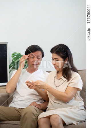 Wellness and Support. Elderly couple sharing health advice while seated together. 126760044