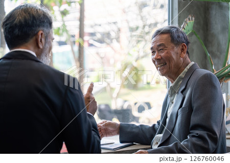 Elderly man smiling during a business conversation 126760046
