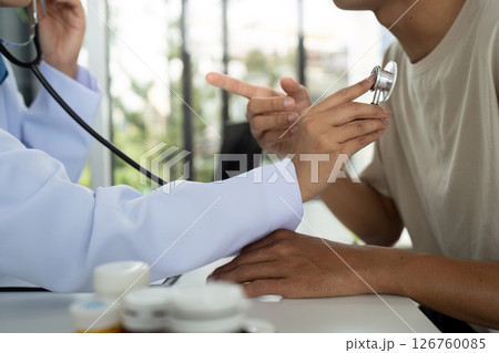 Health and Wellness. Doctor consulting with a patient during a medical examination. 126760085