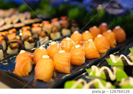 Colorful sushi platter Gourmet salmon sushi rolls served on a black plate with garnishes, ready for a fine dining experience 126760126