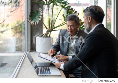 Elderly man discussing business strategies with colleague 126760325