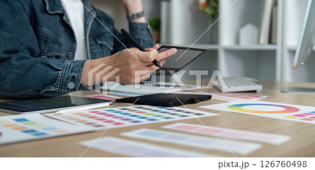 Design Workflow. Professional designer creating digital concepts with tablet and color samples. 126760498