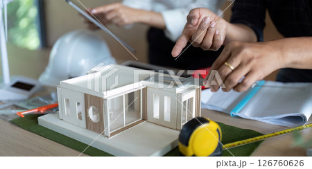 Eco-Friendly Engineering. Engineers collaborating on sustainable building model. Eco-Friendly Engineering. Engineers collaborating on sustainable building model. 126760626