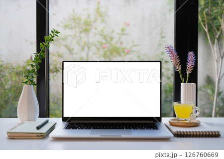 Laptop with white screen and pineapple juice and purple flower, cozy indoor work space 126760669
