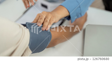 Health and Wellness. Nurse measuring blood pressure on patient. Health and Wellness. Nurse measuring blood pressure on patient. 126760680