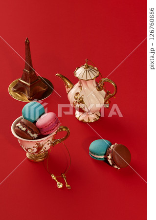 French macarons, teapot and eiffel tower on red background representing paris lifestyle 126760886