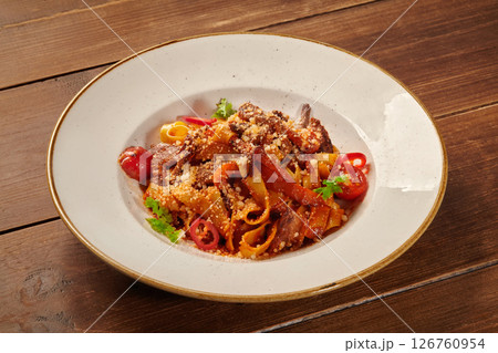 Pappardelle pasta with beef and vegetables on wooden table Pappardelle pasta with beef and vegetables on wooden table 126760954