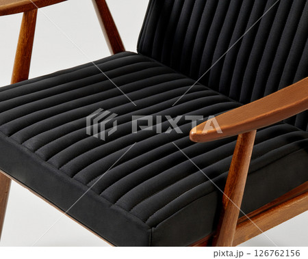 Modern lounge chair with black upholstery and wooden frame displaying comfort and style 126762156