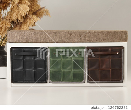 Modern entryway bench featuring stylish storage boxes with padded seat Modern entryway bench featuring stylish storage boxes with padded seat 126762281