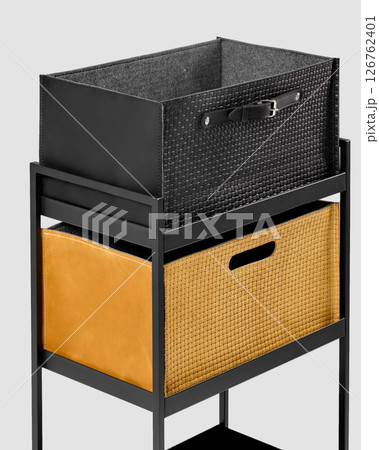 Modern shelving unit displaying stylish storage baskets with leather and woven details 126762401