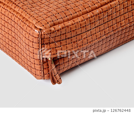 Corner of brown woven leather bag showing zipper detail Corner of brown woven leather bag showing zipper detail 126762448